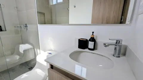 Pristine master bathroom featuring elegant vanities.